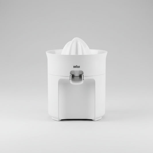 Braun citrus juicer on a kitchen counter with fruits and juice.
